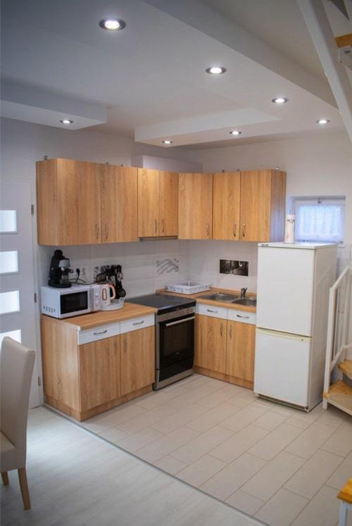 Multiple electrical appliances in a small modern kitchen dining area